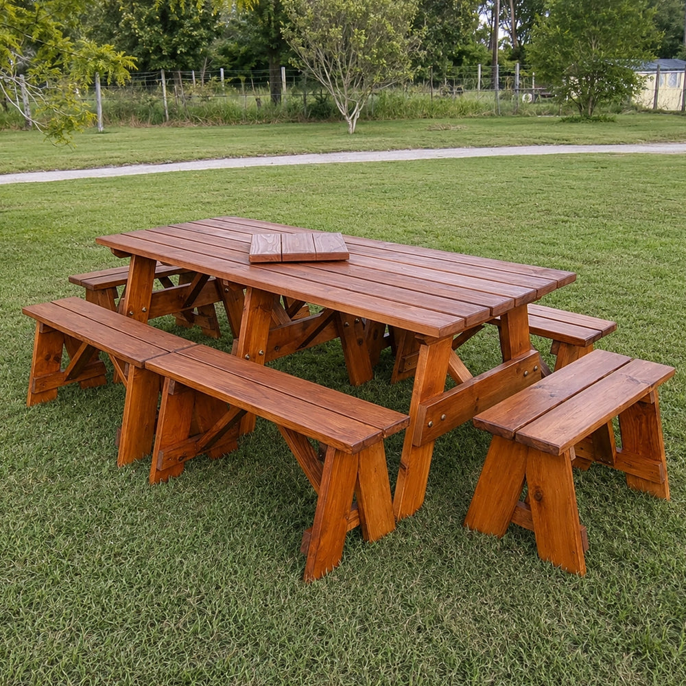 A wooden picnic table with matching benches in an outdoor grassy park setting. Handmade by JJ Timber Designs
