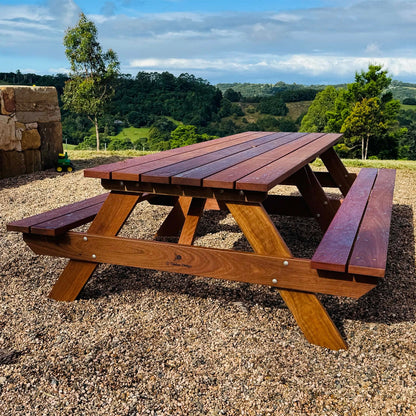 Premium hardwood picnic table overlooking a scenic outdoor landscape.