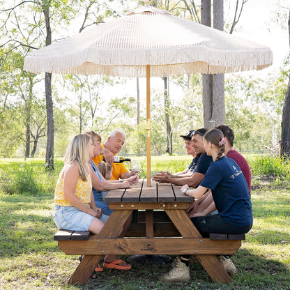 Group seated comfortably around JJ Timber 2.4m heavy duty picnic table outdoors.