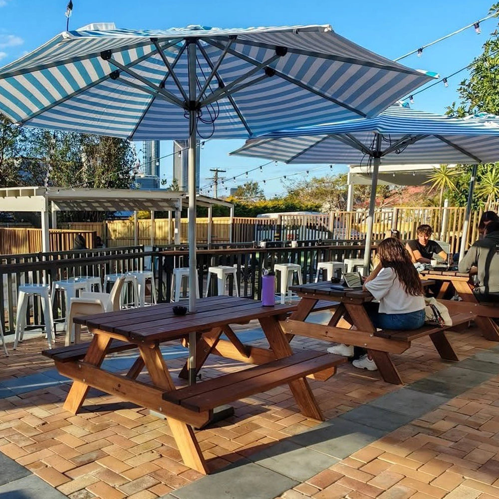 Commercial timber picnic tables by JJ Timber Design installed at Brisbane café outdoor seating area, built for heavy public use