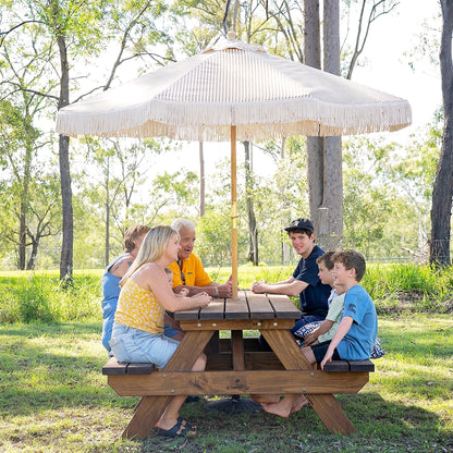 Family gathering around JJ Timber 2.4m heavy duty picnic table in natural park setting.
