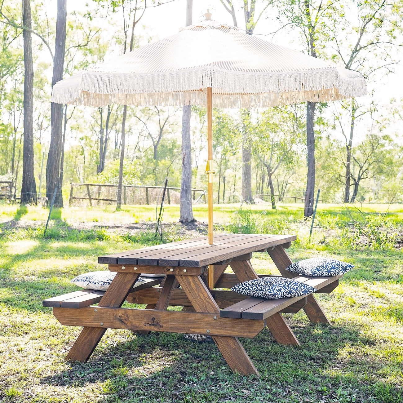 JJ Timber heavy duty picnic table displayed in outdoor landscape with shade umbrella.