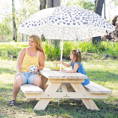 Kids sitting around JJ Timber timber kids picnic table in outdoor play area.