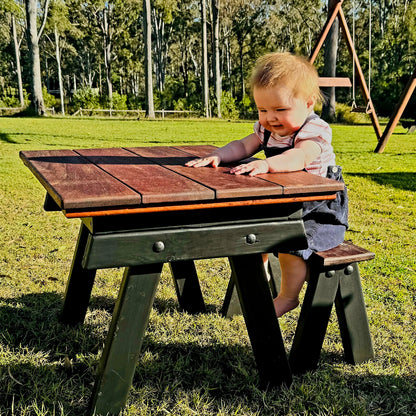 A child plays at a sensory table featuring a removable wooden lid, allowing a switch between flat tabletop and sensory-tub play. Ideal for childcare centres, backyards, and early learning play.
