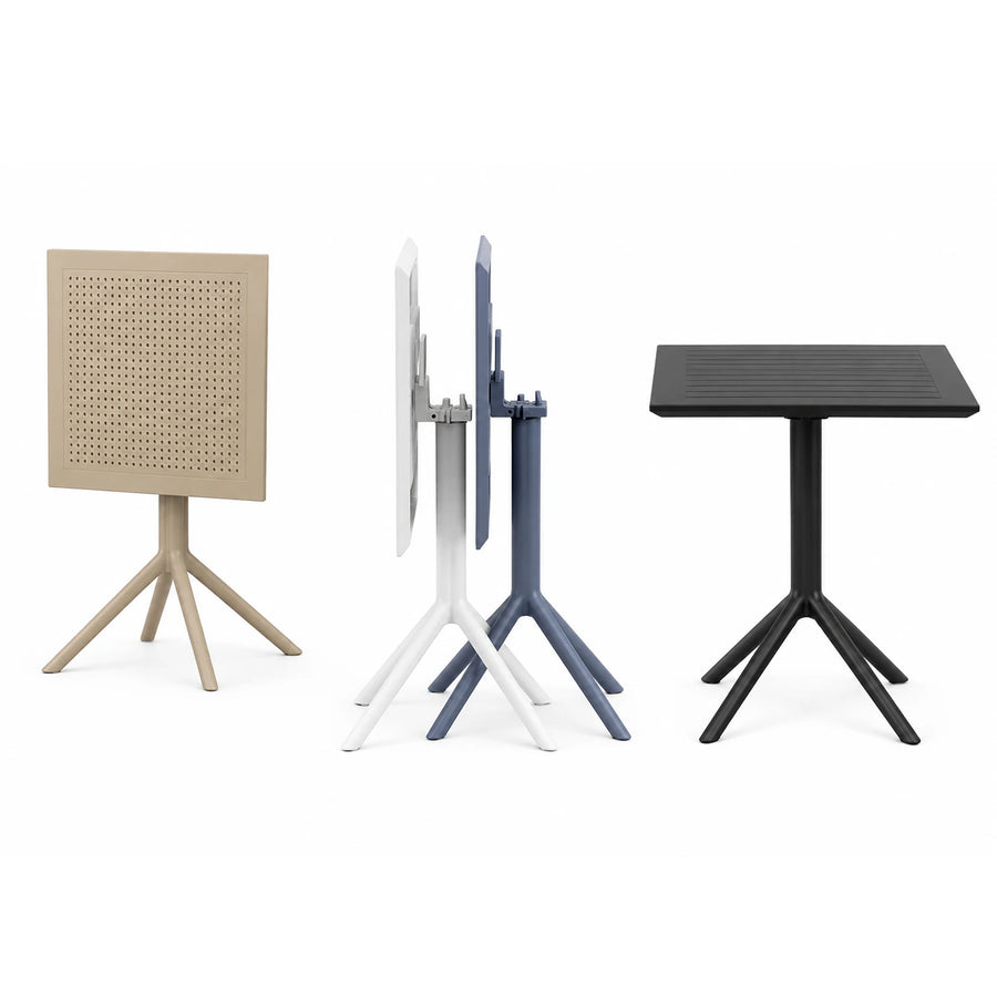 Three folding outdoor tables shown on a clean white background: a beige table with a perforated square top, a white and blue table folded in the middle, and a black table standing open on the right. JJ Timber Design Commercial Products