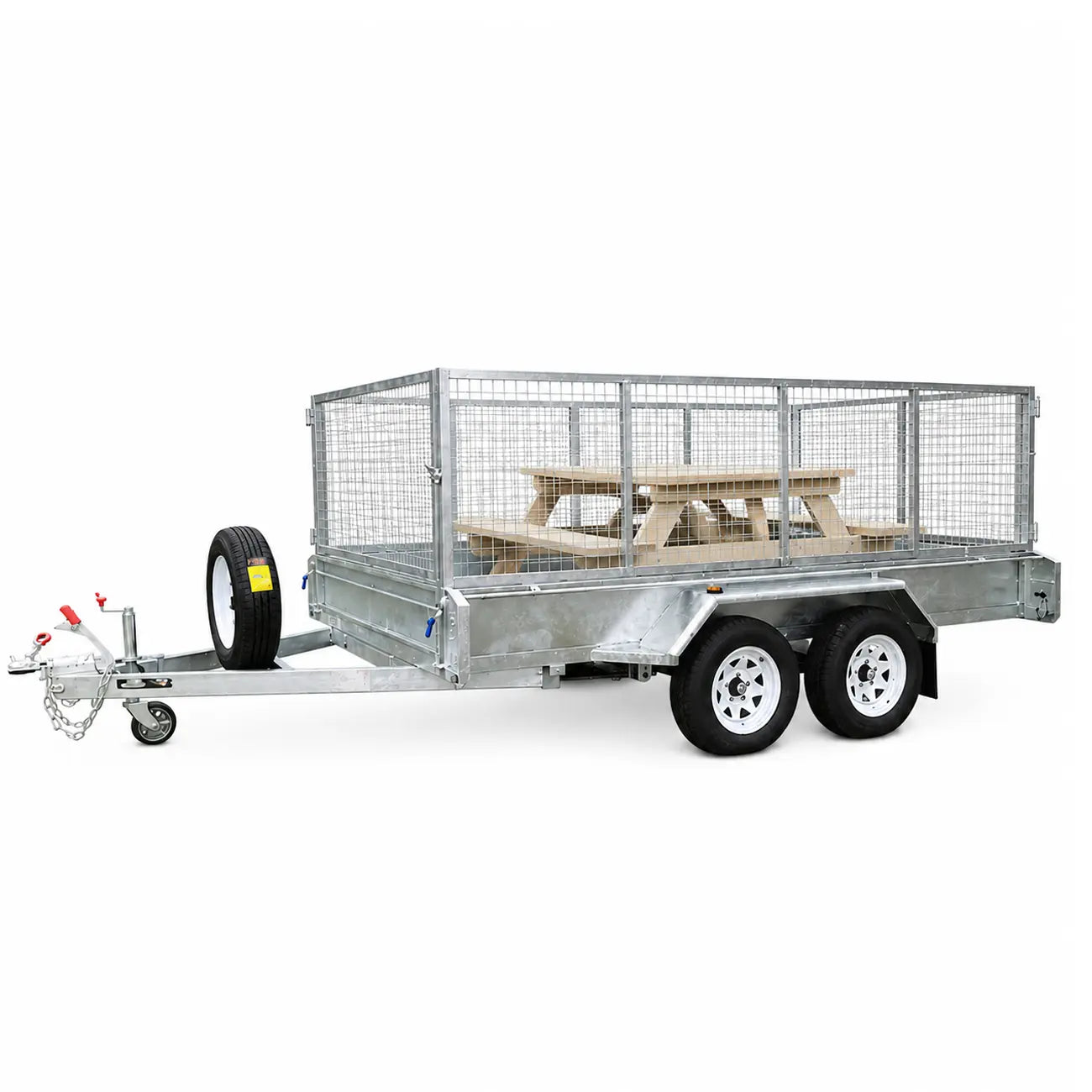 Galvanized steel utility trailer with wire mesh sides and a wooden picnic table inside, shown on a white background.