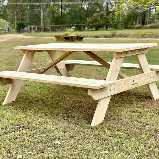 Custom timber picnic table built for outdoor use on grassed grounds