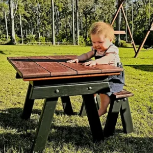 Child playing with toys at a JJ Timber Design sensory table with wooden lid.