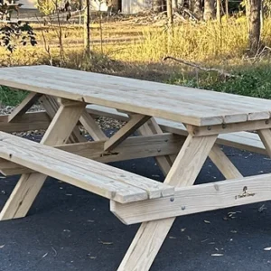 Grey-washed JJ Timber Design picnic table outdoors in natural park.