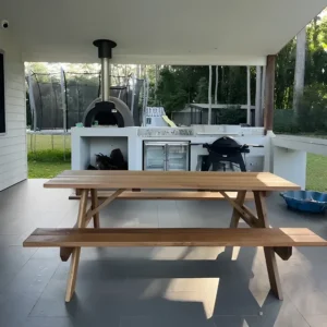 JJ Timber Design timber picnic table arranged on a patio with outdoor furniture.