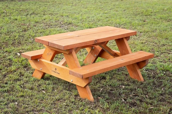 JJ Timber kids picnic table finished with natural timber oil outdoors.